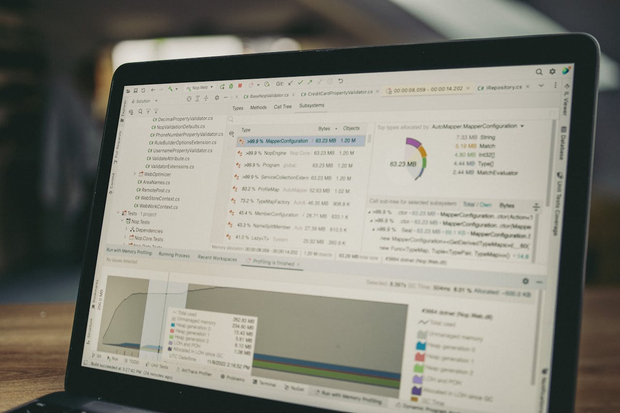 A close-up view of a laptop screen showing a coding and data analysis software interface in an indoor setting.